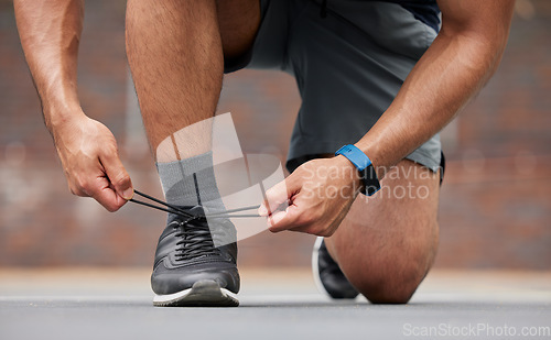 Image of Person hands, sports and tie shoes for running workout, training and action performance on ground outdoor. Closeup of athlete, runner or lace sneakers for exercise, marathon or prepare cardio fitness