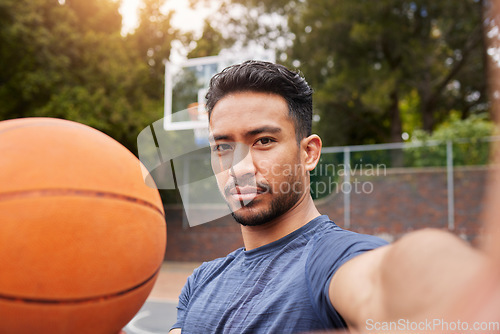 Image of Man, basketball player and portrait selfie on court for social media, fitness blog or training match vlog. Face, pov or Mexican athlete with ball for exercise, workout and sports photography in games