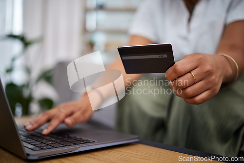 Image of Woman, laptop and hands with credit card in ecommerce, payment or fintech banking on sofa at home. Closeup female person or shopper with debit on computer app in online shopping, purchase or buying