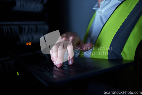 Image of Engineering, night and hands of person on laptop for maintenance, repair and inspection in server room. Information technology, dark and IT technician on computer for analysis, data and control panel