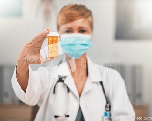 Image of Face mask, portrait or doctor with pills in hospital clinic for healthcare, medicine and supplements. Wellness, medication or hand of physician holding drugs, prescription product or tablet cure