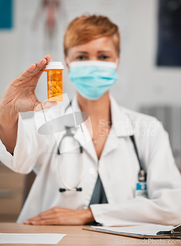 Image of Pills, portrait or doctor with medicine in hospital clinic for healthcare, wellness and supplements. Face mask, medication or female physician holding drugs, prescription product or tablet cure