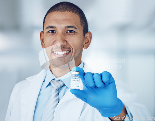 Image of Portrait of man, doctor and vaccine bottle in hand for covid in hospital, safety and pharmaceutical drugs. Healthcare, medicine and medical professional with sample for corona vaccination in clinic.