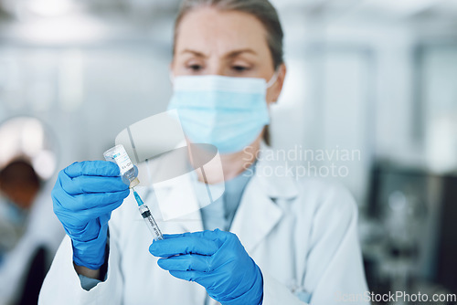 Image of Woman doctor in mask, needle and covid vaccine bottle for hospital laboratory research. Healthcare, medicine and medical professional with sample syringe for corona vaccination in pharmaceutical lab.