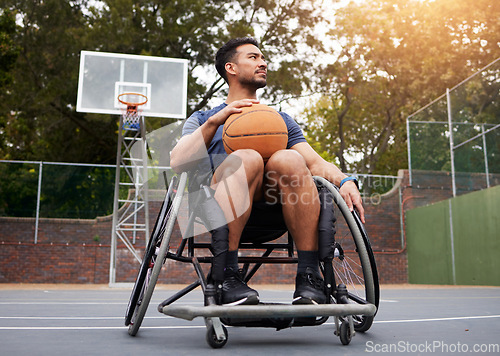 Image of Sports, wheelchair and man with basketball at outdoor court for fitness, training and cardio. Exercise and person with a disability at a park for game, workout and resilience, challenge or mindset