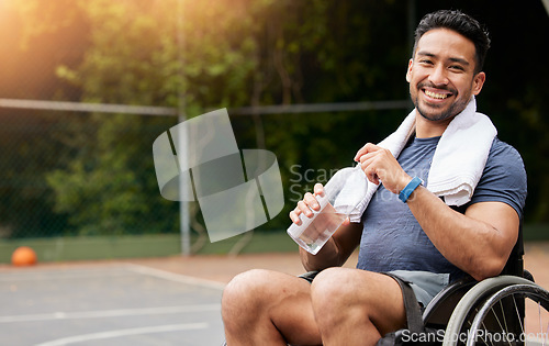 Image of Basketball player, portrait and athlete in wheelchair drinking water for sports break, rest and fitness electrolytes. Person with a disability, Asian man and bottle for workout recovery on court