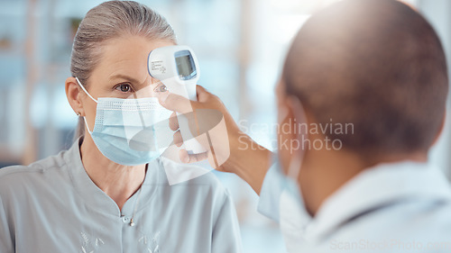 Image of Woman in face mask, doctor and thermometer in office for covid test, safety and healthcare in hospital consultation. Temperature check, corona and patient at clinic with medical professional for exam