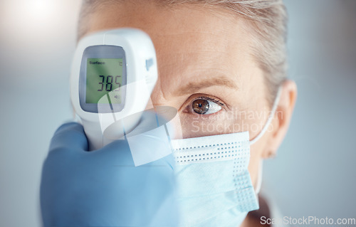 Image of Woman in mask, hand of doctor and digital thermometer in hospital for covid, safety and healthcare consultation. Temperature test, corona and patient at clinic with medical professional for exam.