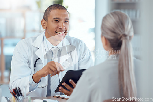 Image of Tablet, office and doctor consulting a patient in a health conversation or communication during medical consultation. Medicine, healthcare and professional talking to person for results in a clinic