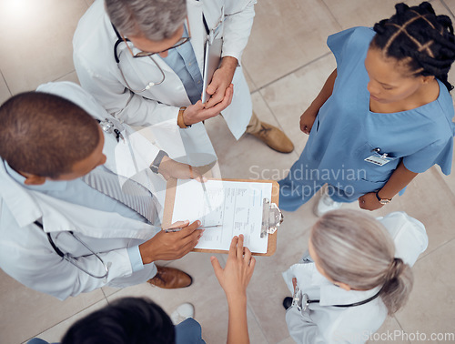 Image of Group of doctors, nurses and checklist in hospital from above, meeting and planning surgery or schedule. Healthcare, discussion and medical staff with clipboard, info and talking together in clinic.