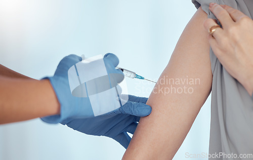 Image of Doctor, arm injection and vaccine for patient in healthcare clinic, virus protection and wellness services. Closeup of needle, hands of medical nurse and medicine for safety, risk and sick immunity