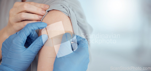 Image of Doctor, arm and plaster on patient for vaccine in healthcare clinic, virus protection and wellness services. Closeup hands of nurse with medical bandage for safety, risk or immunity with mockup space