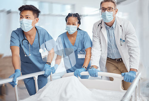 Image of Rush, bed and doctors in hospital for emergency operation in ER with a sick patient or face mask. Surgery team, pushing or surgeons in the theater for surgical medicine procedure or risk treatment