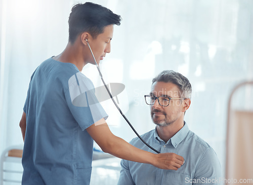 Image of Doctor, asian man and listening with stethoscope to patient heartbeat, healthcare consultation and cardiology test in clinic. Medical worker check heart, lungs and breathing assessment in hospital