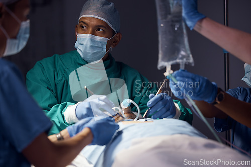 Image of Surgery collaboration, man or surgeon operation, hospital emergency aid or expert helping, support and healing patient. Medical procedure, accident injury or healthcare doctors saving client at night