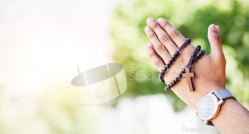 Image of Faith, hands praying and rosary in garden with mockup, praise and religion with holy mindset. Christian prayer beads, cross and person in worship in nature with hope, spiritual gratitude and space.