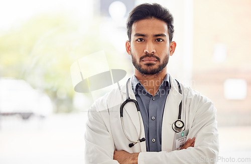 Image of Serious, arms crossed and man doctor portrait in hospital with stethoscope, attitude and determined mindset. Proud, face and Japanese health expert worker in a clinic for help, advice and service