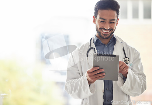 Image of Doctor, asian man and tablet with smile in hospital for planning, research and consulting on blurred background. Clinic, schedule and Japanese male health expert on app for Telehealth, help or advice