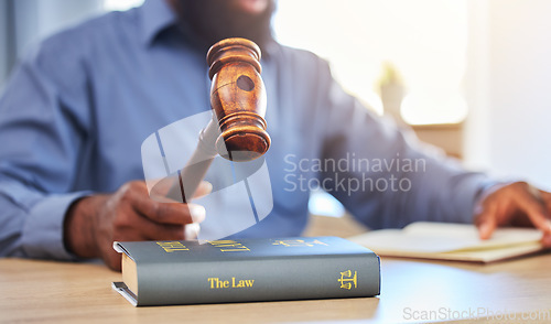 Image of Hands, lawyer and gavel on books in office for attention, guide and justice in courtroom, law firm or truth. Closeup of hammer, legal knowledge and man for consulting attorney, judge and constitution