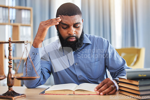 Image of Black man, lawyer and reading book with stress in office from worry, pain or frustrated with challenge of court case. Confused advocate, attorney and headache from legal research analysis in law firm