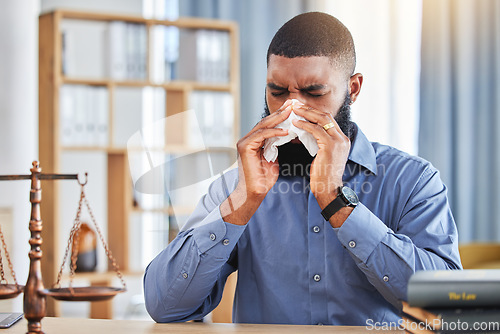 Image of Lawyer, sick and business with black man and blowing nose in office for allergy, illness and fatigue. Advocate, attorney and sneeze with male employee and tissue for virus, infection and hayfever