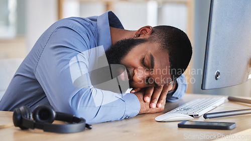 Image of Call center, tired business man and sleeping at desk with burnout, fatigue and low energy in telemarketing office. Lazy, depressed and stress of african sales consultant taking a nap in CRM agency