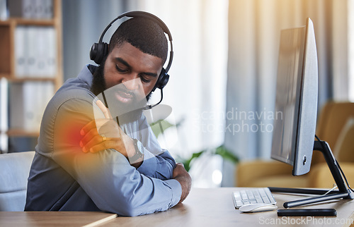 Image of Call center, customer support and black man with shoulder pain, muscle strain and injury at desk. Telemarketing, business and male consultant with inflammation for communication, crm help and contact