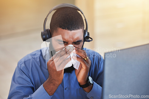 Image of Sick, man and blow nose in call center office for flu, allergies, and health risk in telemarketing agency. Face of african salesman, CRM agent and tissue for virus, bacteria and sneeze for allergy