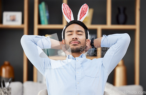 Image of Bunny ears, easter and business man sleeping or tired in an office feeling lazy on holiday and bored after party in office. Hangover, rabbit and employee or person with fatigue, burnout or overworked