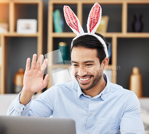 Image of Business man, bunny ears and laptop with video call, wave and smile for contact, networking and festive fashion. Entrepreneur, rabbit emoji and webinar with computer, hello and funny for Easter party