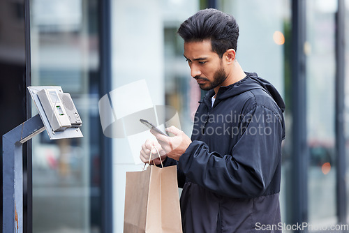 Image of Courier man, paper bag and street with phone, typing and delivery app for service in supply chain job. Young logistics worker, package and thinking with smartphone, product or e commerce in metro cbd