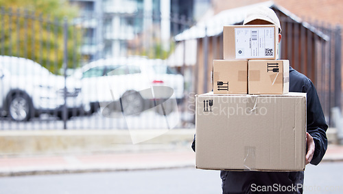 Image of Courier person, street and walking with boxes, service and delivery in urban city for supply chain job. Logistics worker, package and road for customer satisfaction, product and commerce in metro cbd