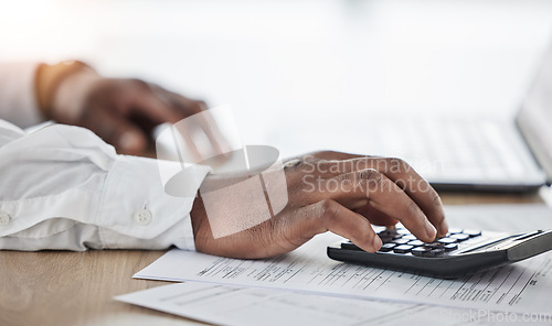 Image of Business person, hands and calculator, documents and laptop for financial planning, taxes management and debt. Accountant typing numbers for budget, math or investment paperwork on computer and desk