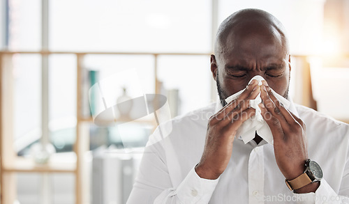 Image of Sick, tissue and businessman blowing his nose in the office with cold, flu or sinus allergies. Illness, medical and professional young African male person with hayfever while working in the workplace