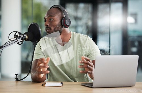 Image of Black man, microphone and talk show, headphones and radio DJ with news, communication and audio equipment. Podcast, technology and multimedia with male person, laptop with announcement and broadcast