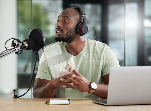 Image of Black man, microphone and laptop, headphones and radio DJ with news, communication and audio equipment. Podcast, technology and multimedia with male person, talking with announcement and broadcast