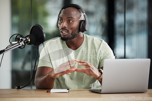 Image of Black man, microphone and talking with headphones and radio DJ, news with communication and audio equipment. Podcast, laptop and multimedia with male presenter, hosting show and online broadcast