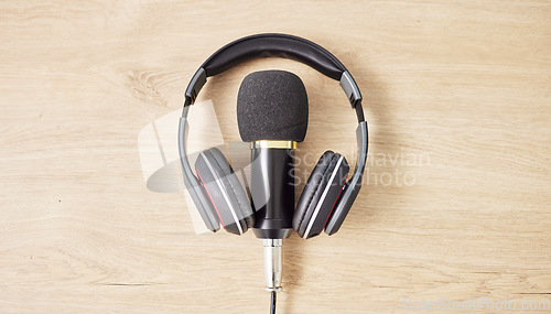 Image of Audio, microphone and headphones on a table for a podcast, radio or broadcast. Music, above or musical gear, equipment or a mic for live streaming, musician recording or technology in an office