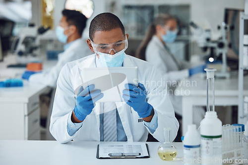 Image of Man, tablet and face mask in science laboratory for medical virus research, medicine and vaccine development. African scientist, person and technology for DNA healthcare and genetic disease control