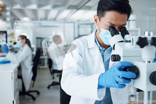 Image of Microscope, scientist and asian man working in laboratory to review virus research, medical test and biotechnology. Science, microbiology and investigation of innovation, dna analysis and experiment