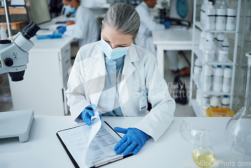 Image of Senior woman, scientist and lab writing for research and notes for medical analysis. Info, investigation and laboratory documents for covid and healthcare report with paperwork and data planning