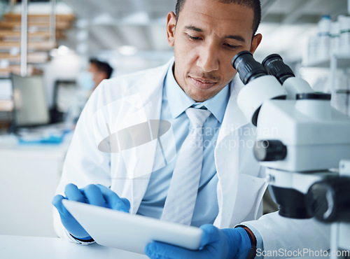 Image of Microscope, science and man with tablet in laboratory for research, medical analysis and biotechnology. Scientist, microbiology and investigation with digital technology, dna testing and development