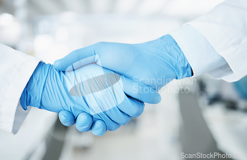 Image of Team handshake, gloves and lab scientist partnership, agreement or collaboration on medical healthcare project. Laboratory, shaking hands and closeup people teamwork, cooperation and welcome partner