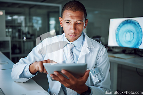 Image of Man, night or tablet in science laboratory for medical research, deadline or pharmacy wellness. African scientist, person or working late on digital technology, DNA healthcare or genetic engineering