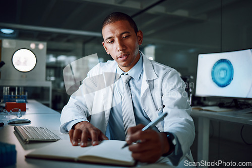 Image of Doctor, writing and night in laboratory for medical research and study for healthcare report. Paperwork, African male professional and planning with data for biotechnology in a clinic or hospital