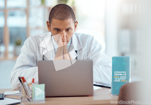 Image of Hospital, laptop and doctor with covid stress, bad report or Corona issue with negative news, pressure or fatigue. Male person, medical professional or online info with a pc, anxiety or test results