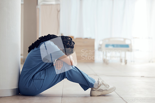 Image of Healthcare, woman on the floor and stress with depression, intern and panic attack with burnout. Person, medical professional or sad nurse on the ground, mental health issue and anxiety in a hospital