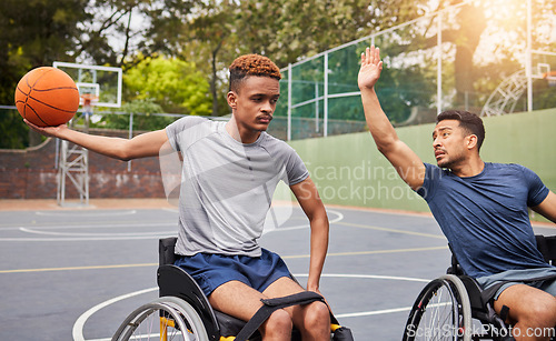 Image of Sports, basketball and men in wheelchair for training, exercise and workout on outdoor court. Fitness, team and male people with a disability with ball playing for competition, practice and games