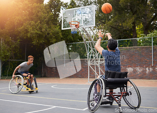 Image of Sports, basketball and men in wheelchair for goal in training, exercise and workout on outdoor court. Fitness, team and male people with a disability shoot ball for competition, practice and games