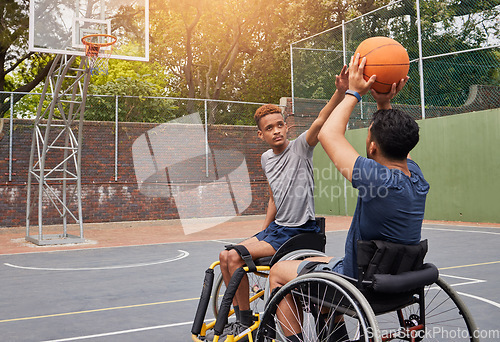 Image of Sports, wheelchair basketball and people shooting ball in match competition, challenge game or fitness practice. Player defence, shot and young athlete with disability, training and exercise on court